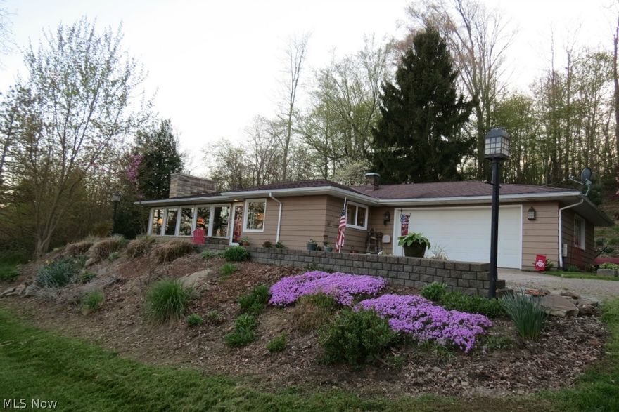 Beautiful ranch home in a tranquil hilltop setting overlooking the Muskingum River valley.  Spacious open floor plan. Picture windows front and back with fantastic nature views. Kitchen updates in 2014 include solid surface countertops,  porcelain slate backsplash, wide plank floors, and new stainless appliances. Property also includes quaint patio area, 2 storage sheds,  and a spring house all on approximately 6 acres just outside Coshocton. Don't miss this opportunity!  Call now for your personal showing.