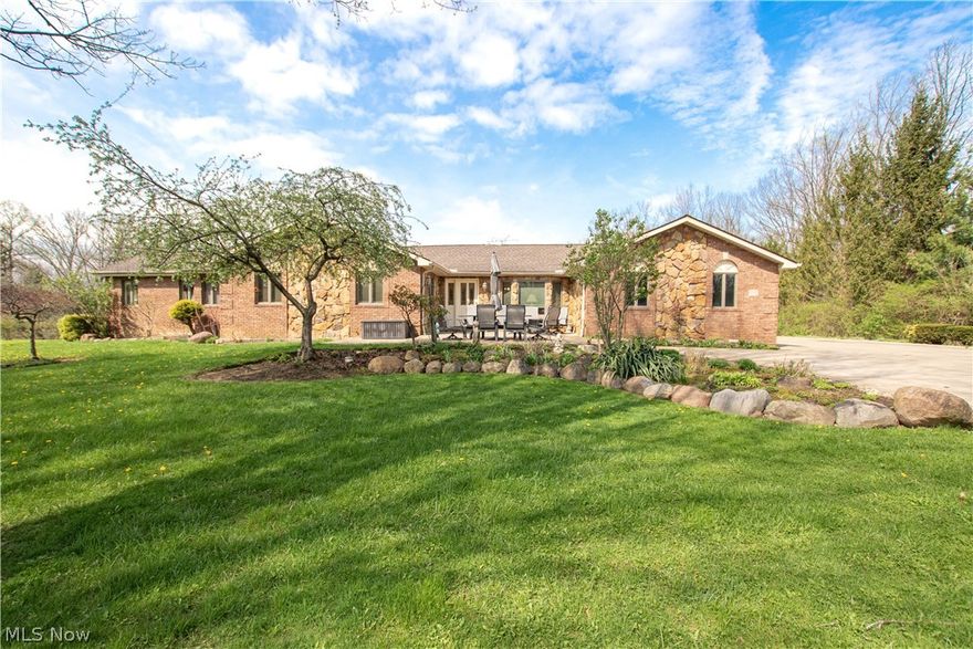 Tucked away on 3.6 beautiful acres, this 4-bedroom ranch offers space, comfort, and a setting that’s hard to forget. Inside, the vaulted great room makes an immediate impression with newer LVP floors, a fireplace, lots of built-ins, and gorgeous views of the pond that bring the outdoors right into the heart of the home. The large eat-in kitchen is perfect for both everyday living and entertaining, with a breakfast bar, double oven, and open sightlines to the great room. Just beyond, the dining room is ready for everything from casual dinners to big holiday gatherings. Solid wood doors and hardwood floors flow throughout the house. The primary suite offers a peaceful place to unwind, complete with sliding doors overlooking the pond, a generous walk-in closet, and an additional cedar closet. You’ll also appreciate the convenience of first-floor laundry and a versatile bonus room that can easily serve as an office, playroom, craft room, or flex space. The full walk-out basement adds even more functionality with a second kitchen, extensive storage, and plenty of room for hobbies. Outside, the property feels like your own private retreat, with a spring-fed pond (full of trout, bass, and blue gill), front courtyard, and plenty of room to relax and enjoy the view. The detached outbuilding is full of potential and ready to be reimagined to fit your needs. Every part of this home reflects a sense of comfort, care, and pride that has stood the test of time. Updates include hot water tank (2026), water softener (2020), flooring (2023), roof (2018). All of this located in Revere Schools and just minutes from I-77 and I-80. This is an easy place to call home!