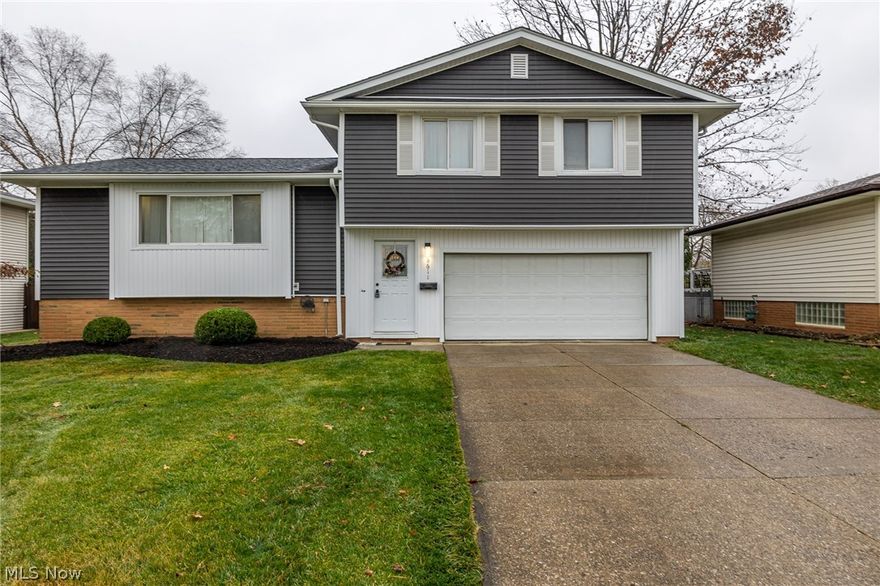 Gorgeous Parma Heights Split Level home and has been well maintained and is in move in ready condition! The windows were replaced in 2016, siding, roof and insulation in 2020, hot water tank 2022.  You'll be welcomed to this nice quiet neighborhood by a sharp home, with great curb appeal and a yard that is just the perfect size. Upon entry through the garage or front door is a foyer/mud room, equipped with great storage space and a bench for putting on your shoes and boots. The hardwood floors in this home have been beautifully refinished and the home has been freshly painted. You'll love the open flow of the living room, dining room and kitchen, great for everyday living and entertaining, plus the slider opens to a deck, covered patio and fully fenced yard. Call today for your private showing, this beauty won't last long!