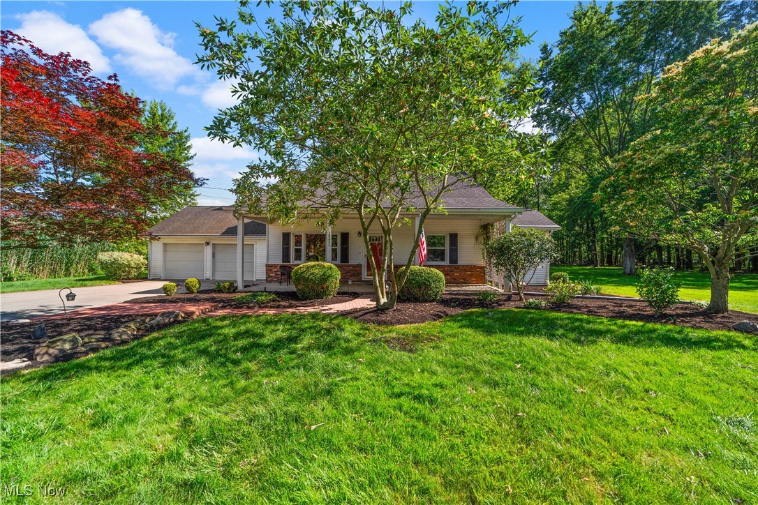 Welcome Home! Serenity at its finest! This well kept home on a private lot with 2 vacant adjacent lots is sure to please! The inviting backyard is private with wooded views and plenty of recreation space and privacy. An inviting covered front porch and curb appeal is sure to please. The heart of the home boasts a functional kitchen that includes all appliances. A vaulted great room with full wall fireplace and views of the backyard is sure to please for gatherings and lounging. A flex space for a dining room or formal living room gives the home versatility and personal functional living needs. A first floor owner's suite with walk-in closet and spacious master bath is sure to please any owner. A second bedroom/office is located on the first floor. Two additional bedrooms are located on the second floor. Full block basement with newer mechanicals. Back covered porch. Extra garage space is located in the rear of the attached garage. Professionally landscaped. Metroparks within walking distance. Award winning North Ridgeville Schools. Great location to all major highways. Don't miss the opportunity!