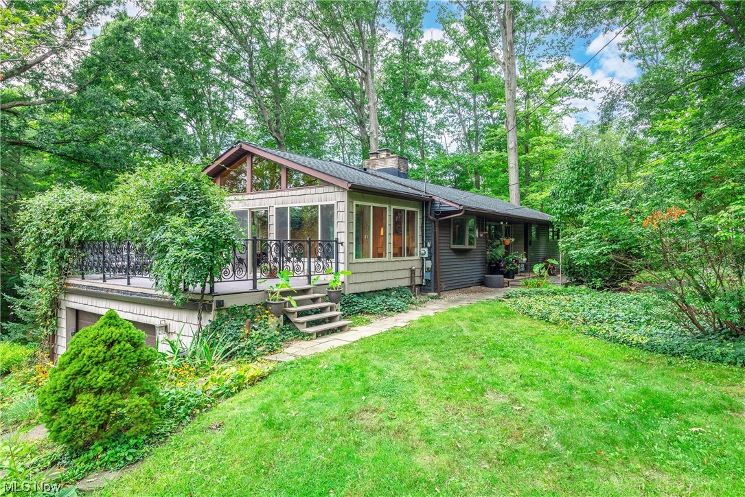 Welcome to 242 River Road. Relaxing front porch to greet you. Step in the front door, walk across the Black Walnut hardwood floors to a wall of floor to ceiling windows overlooking 3.99 acres of wooded paradise. Watch the sun rise and set from 24' X 12' newly carpeted Sun room that could be heated year round. A true mid-century Roman brick fireplace graces the main floor with beautiful updated kitchen with ceramic floor, breakfast bar and formal dining room with great views & 3 bedrooms & updated full bath. Lower level is a walk out & offers possible in-law suite or teen suite with full kitchen, 2nd fireplace, huge 4th bedroom with newer floor, walk in closet and gorgeous full bath. New C/A 22', Roof 2015, new drive 2014 & sealed 2022. One year peace of mind Home Warranty included. Located in prestigious Highland School system and minutes from I71, I77, & I271. Come take a look.