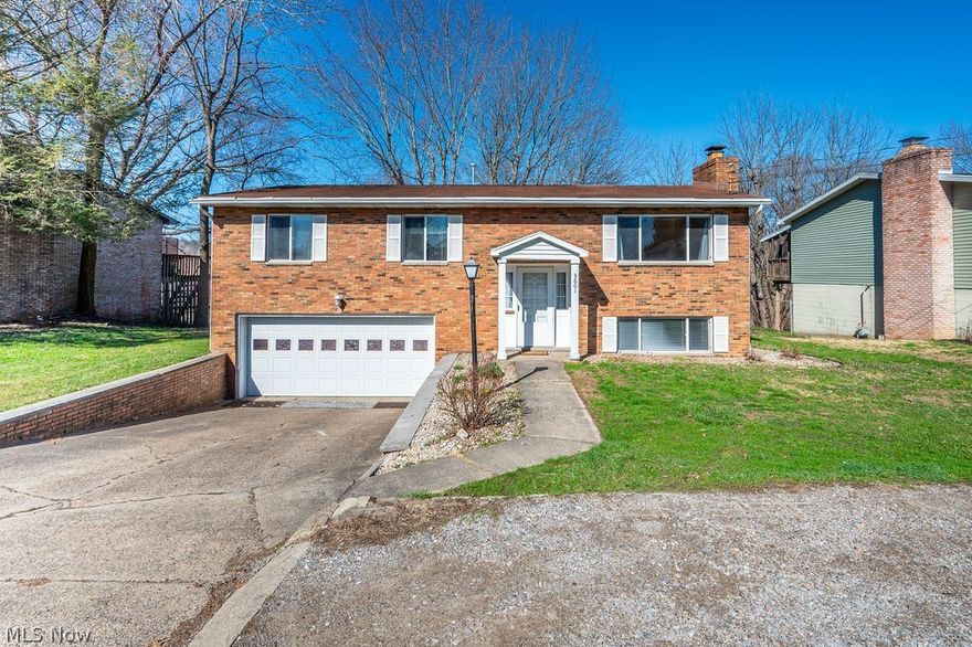 Welcome to this well maintained 3 bed 2.5 bath split entry brick home in Vienna on 1st Ave/River Rd. A bright and airy ceramic tiled entryway opens to the main living area and the large downstairs rec room with wood burning fireplace. Downstairs also has a laundry room and 1/2 bath along with a large storage closet and a walk out to the fenced back yard. The main level features consistent LVT wood tone flooring throughout with freshly  painted walls. There are 3 bedrooms and two updated full baths on the main level for both en suite and guest convenience. The ceramic tiled kitchen has ample cabinetry opens to the formal dining area or out to the huge screened covered back deck extending the length of the home with peaceful views of trees and glimpses of the Ohio River. Two car garage and off street parking add to the comfort and conveniences this property provides. You are close to everything but it feels off the beaten path. Schedule your showing today.
