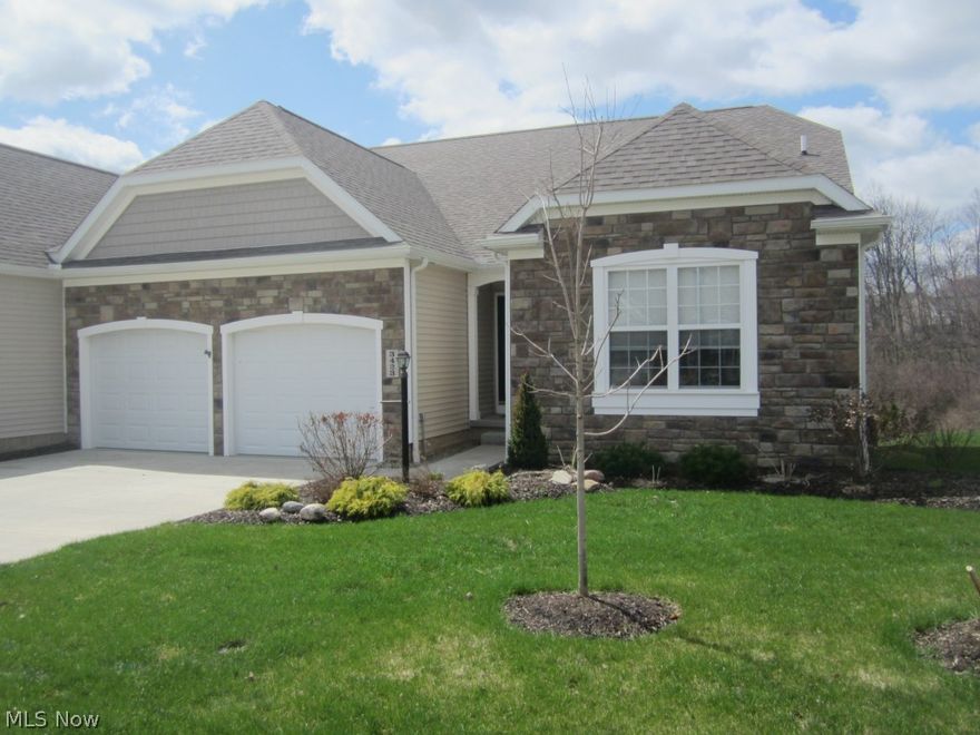 Approx. 2,900 s.f. of Gorgeous custom finishes throughout! Open floor plan with hand-scraped hickory floors in main living areas, ceramic tile in all baths & laundry. Granite and solid surface counters. Fully applianced kitchen (incl. wine cooler) with cherry cabinetry, tiled back-splash, custom island, and views to great room, sun room and woods. Owners bedroom has coffered ceiling, large walk in closet and access to private deck. Owners bath has custom shower with dual spray heads, and dual sinks. First floor office with 15 lite french doors. Solid core doors throughout. Lower level boasts 9' ceilings, large family room with stone fireplace, wet bar, and exercise area. Lower level third bedroom with walk in closet and bath access. Plenty of additional room for storage. Private rear yard with  wooded protected land and meandering stream. 26' x 12' deck with patio below. This home/condo will not disappoint!