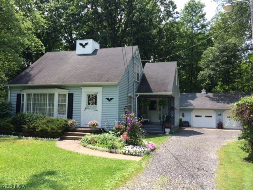 City close....Country quiet.  Charming Cape Cod situated on almost 10 wooded acres.  Features include 3 BR's (downstairs BR being used as a den), 1 1/2 baths, fireplace in LR.  Hardwood floors under carpet in LR & den.  Furnace, air & roof replaced 15 yrs. ago.  FREE gas available.  Woods were timbered approx 15 yrs. ago taking trees only 18" in diameter.  Probably ready to be timbered again.  2+ Garage and heated workshop add to this homes appeal.