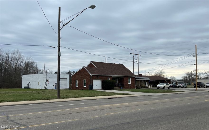 Zoned commercial.  Well Kept Brick Cape Cod and Huge Heated 1500 square foot Work Shop/Garage with 14' Door.