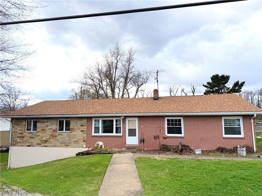 Welcome summer in style with this spacious brick ranch featuring a stunning skylit great room and a backyard deck made for relaxing evenings and weekend cookouts. Inside, you'll find generous living areas including a comfortable main living room, an eat-in kitchen with abundant cabinetry, and three bedrooms on the main level.

The true centerpiece of the home is the dramatic cabin-style great room showcasing vaulted ceilings with exposed beams, skylights, and a loft overlooking the space. Natural light pours in from above, highlighting the warm wood finishes and creating an inviting atmosphere perfect for entertaining, gathering with friends, or simply enjoying the openness of the space.

Step outside to the rear deck overlooking the deep backyard — an ideal setting for summer cookouts, morning coffee, or quiet evenings outdoors. The yard offers plenty of space to relax, garden, or host outdoor gatherings.

The full basement includes a large rec room along with additional flexible space for hobbies, storage, or extended living needs. Mechanical features include a heat pump providing heating and cooling, fuel oil, as well as, a Woodchuck wood and coal furnace offering three heating options for those cold winter nights.  

An attached garage provides ample room for vehicles, storage, or workshop use.

This property combines spacious living areas, distinctive architectural character, and outdoor space ready to enjoy all summer long. Schedule your tour today!