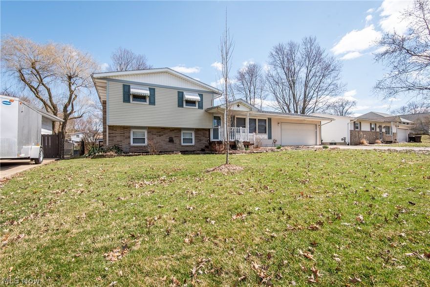COME TAKE A LOOK at this 4 level split in Perry Township.  This 3 bedroom, 1.5 bath home has a lot of features to love.   Original hardwood flooring in many of the living areas make a nice statement.  The kitchen has received numerous updates including cabinets, countertops, sink and appliances.  The wall from the kitchen to the dining area was removed to allow for large dinette.   Off the dining area, there are sliding doors to the 3 season sun room.  On the 2nd floor, you will find 3 bedrooms all with hardwood flooring and a full bath with tile flooring and decorative tile backsplash.  The lower level offers additional living and entertaining space with a family room, half bath, and an extra space which might make a great home office.  The best part of a 4 level split is you have all this living area plus plenty of room for storage in the unfinished basement.  Outside, enjoy the fully fenced yard, fire pit, area for your grill and patio set, plus multiple outbuildings for increased s