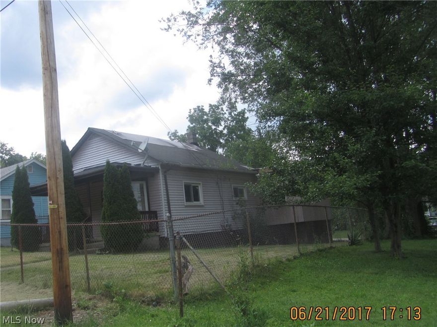 Low maintenance aluminum sided home with chain link fenced double lot, off street parking with frontage on 2 streets. Modern kitchen with laminate flooring, covered front porch and shed.  Cash only with proof of funds required with all offers.