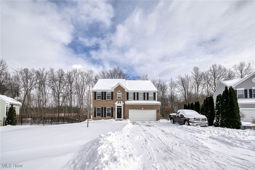 Welcome home to this stunning, light-filled beauty showcasing a calm, neutral color palette that creates a warm and inviting atmosphere throughout. The brick front and updated shutters give this home a beautiful stately grand appearance upon arrival. Immediately on entering you are greeted with a gorgeous view from entry straight through to the massive wall of windows to the back of home. Graceful columns define the entry and formal dining. The two-story vaulted family room features a dramatic floor-to-ceiling stone fireplace and a breathtaking wall of windows that fills the home with natural light and gives you a beautiful backdrop of nature. The heart of the home is the granite-countertop kitchen with a large center island, plenty of cupboards and work space -- perfect for everyday living and entertaining. Enjoy your morning coffee in the serene morning room, host memorable gatherings in the formal dining room and work comfortably from the private home office. The back of the home features a wonderful multi-level deck, allowing ease of enjoyment and relaxation outdoors! The primary suite is a true retreat, offering a double vanity, separate soaker tub and shower with seating, and a walk-in closet. The first floor has been updated with LTV plank flooring and the guest half bath updates feature stylish, modern finishes. The lower level has been finished with a full bath, bar and a family room with french doors leading outside to a wonderful patio and fenced rear yard. The fenced yard, double-tier deck and patio are truly the perfect space to relax, play or entertain. The concrete driveway is extra wide, allowing additional parking off to the side of the garage. This home has so many upgrades and extras already done throughout, offering comfort, style, and functionality-an absolute must-see for this price point in all it has to offer!