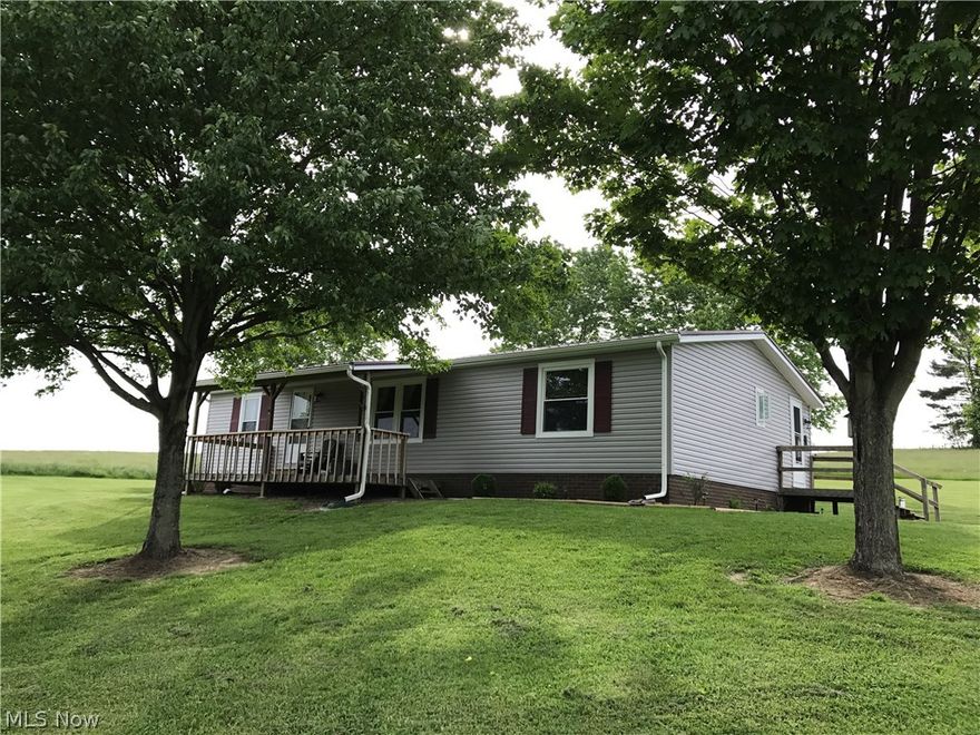 A large Open Concept Manufactured Ranch Home on 1.5 Acres offering quiet country living with seclusion.  This nice 3 Bedroom, 2 Bath home has so much to offer.  A new Metal 40 yr. warranty roof, new vinyl siding, spouting and soffit in 2016.  Well insulated with OSB board and Tyvek wrapping.  You will love the extra large open concept Kitchen with abundant cabinetry, complete with all appliances and washer and dryer.  The home has newer replacement windows, beautiful laminate flooring throughout and you will enjoy many hours relaxing on the nice covered front porch.  This home comes with a 22' x 33' - 3 Car Detached Garage with electric and a 26' x 28' pole building with gravel floor.  The home is wired with an outside plug for a generator.  Don't miss this opportunity!!