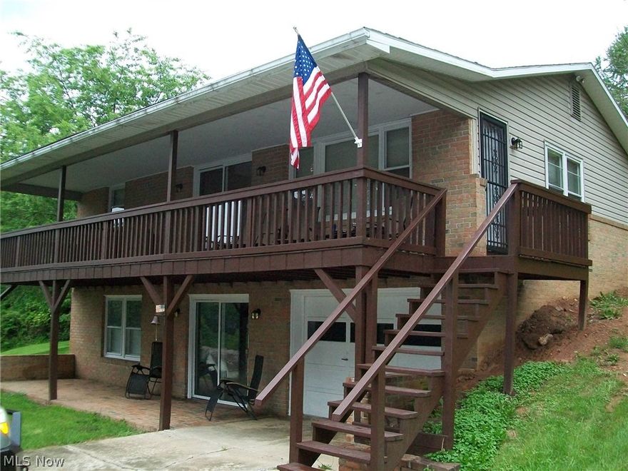 What a Location! In town yet very private, this 3 bedroom 2 bath has over an acre of ground and oversized detached 2 car garage and 1 car lower level garage. Large covered deck with patio below. Enjoy being in town with the privacy of the country.