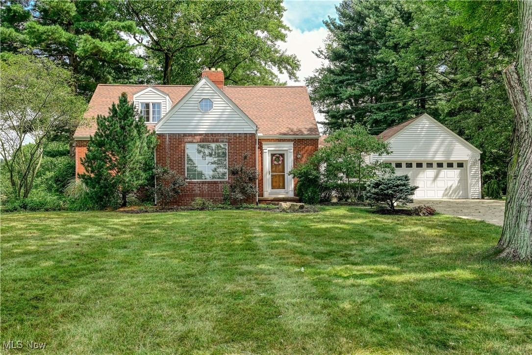 Welcome to this charming Cape Cod situated on over half an acre! Step inside to discover beautiful hardwood floors, gorgeous oak trim, extra-wide baseboards, and solid oak doors that flow throughout the first floor. The spacious living room features a wood-burning fireplace with built-in bookshelves—perfect for cozy evenings. The large eat-in kitchen opens seamlessly into the Great room, where a wood-burning stove adds warmth and character. Sliding doors lead to a paver patio, complete with a fire pit, ideal for entertaining or enjoying quiet nights under the stars. From the kitchen eating area, a second sliding door leads to a private deck—offering multiple options for indoor-outdoor living. Two bedrooms and a full bath are conveniently located on the first floor. Upstairs, a generously sized third bedroom spans the entire second level, offering multiple closets and flexible space for a home office, sitting area, or creative studio. The lower level provides even more space to entertain, featuring a finished rec room and a beautifully remodeled full bathroom. Out back, a 40' x 22' pole barn with large barn doors provides easy storage for your boat, RV, or any toys and tools you need to tuck away. Conveniently located near Kim Tam Park, downtown Hartville, and all the restaurants and shopping in Green. Don't miss out on the opportunity to make this house your home and schedule your private showing today!
