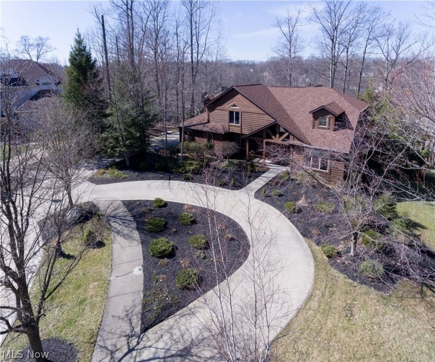 Custom built California contemporary cedar colonial* rolling private treed .5 acres *5,000 SF* crystal chandelier crowns 2 story entrance living room with vaulted ceiling & bay window *dining room, trey ceiling, crystal chandelier  *kitchen with granite, cherry cabinets, island with cook top & seating for 5 *vaulted ceiling family room, window wall great views, fireplace *den with adjacent full bath possible master* finished lower walkout, fireplace, au pair/in law suite, computer/theater room, guest bedroom,  laundry room, full bath. 4 oversize bedrooms on 2nd level. Vaulted ceilings in all •home is in excellent move in condition, newly painted in & out, 3 year old architectural shingles. Home is in the homestead subdivision, featuring unique one of a kind homes.  Just off Royalton & Avery-it is conveniently located for shopping, dining, entertainment & more! Truly a must see!