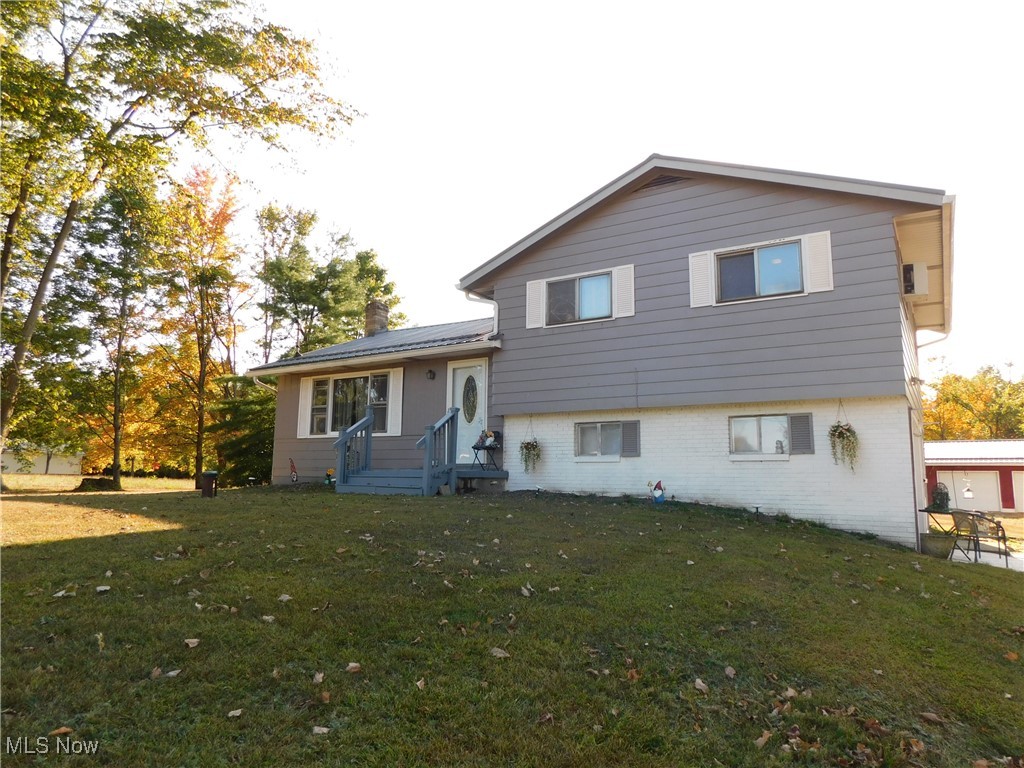 Spacious split level. Hardwood floors and multiple living space. Ground floor consists of 4th bedroom with kitchenette and shower along with a large family room and half bath. 2nd level has eat in kitchen with patio door and large living room. 3rd floor with 3 bedrooms and bath. Large 2-story barn 24x40, 3-car garage and shed. House, barn, garage, and shed with metal roof. All situated on over 4 acres. Gutter Guards on home and garage.