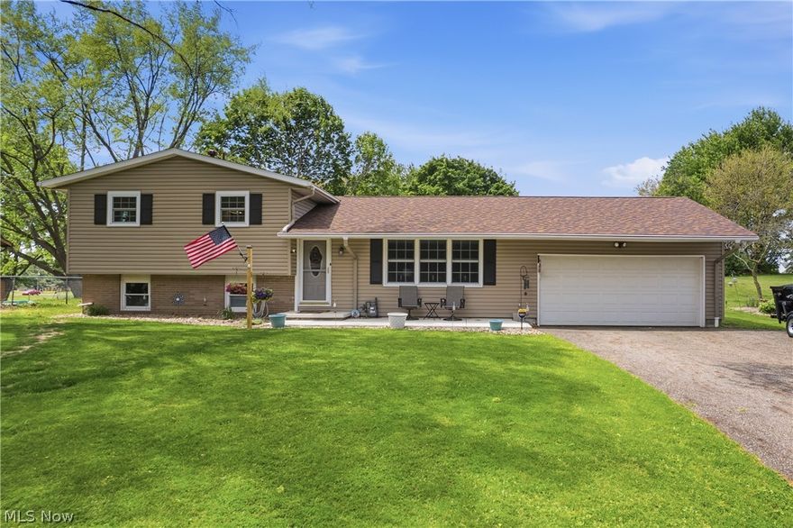 This impeccably renovated split-level is located in the highly sought-after Lake Local School District! Situated on nearly half an acre with mature trees and a private backyard setting, this move-in-ready property combines modern updates with warmth, character, and exceptional functionality. Inside, you’ll find space for the whole family, featuring fresh paint, new trim and moulding throughout, new carpet upstairs, and stylish LVP flooring in the family room and bathroom. The beautifully updated bath showcases a new walk-in shower, vanity, toilet, fixtures, and paneled walls for a designer touch. Cozy up around the custom fireplace and admire the charm of custom accents throughout the home. The kitchen offers both storage and style, with beautiful hardwood cabinetry, updated hardware, and all new kitchen appliances. Sliding patio doors lead directly from the eat-in kitchen to the back deck, perfect for entertaining or relaxing outdoors. Major updates include a new roof on both the house and barn (2024), new patio door and windows (2025), updated outdoor lighting, new outlets, GFCI protection where applicable, switches, and ceiling fans. The front cement porch was also redone in 2024 with improved drainage and sump pump routing. The finished basement adds extra living space, while the laundry and utility room provide additional storage. Outside, the large barn with workshop area is ideal for hobbies, equipment, or extra workspace. This home truly has it all!