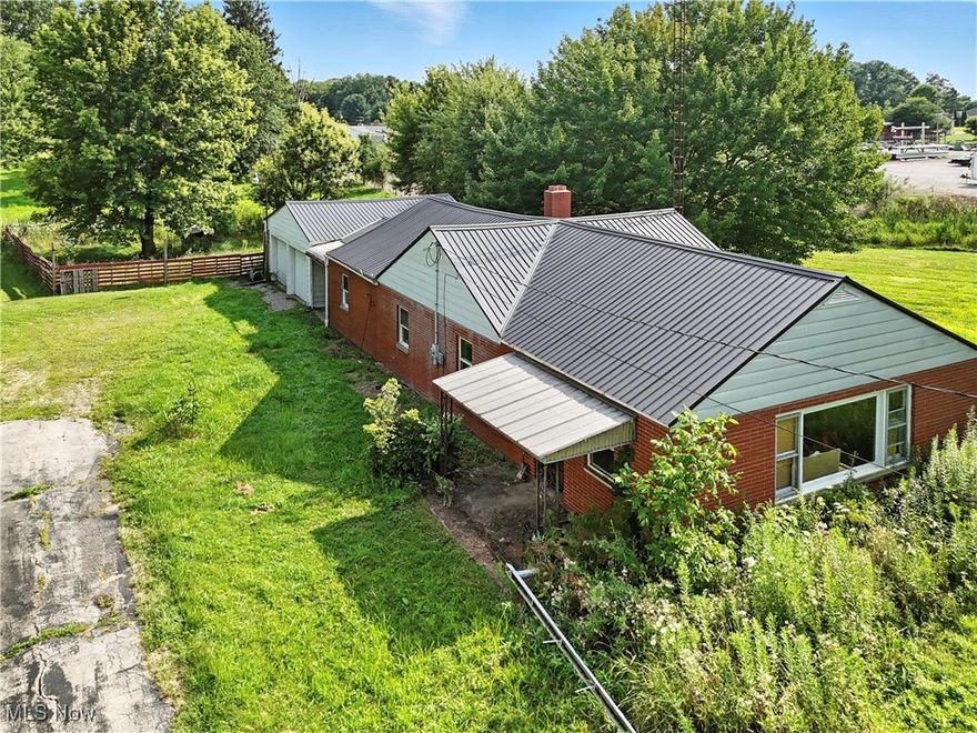 Bring your vision to life with this spacious ranch on 3 lovely acres in West Branch LSD! Currently mid-renovation and being sold as-is, this property gives you a head start toward your dream home or next investment project. An open-concept layout provides a bright, seamless flow between the extra-large living room and the spacious kitchen—perfect for both everyday life and entertaining. A new metal roof adds sharp aesthetic that compliments the classic red brick exterior.

This one-floor home features a private primary suite with full bath, two additional bedrooms, a laundry/utility room, and a second full bathroom. An enclosed breezeway connects the home to the two-car garage and leads to two side porches, one opening to a large fenced area of the yard.

A major bonus: many of the materials needed to complete the renovations are already on site and included in the sale—brand-new sage green kitchen cabinetry, flooring, multiple bath fixtures, and more.

Set on 1.5 acres, right around the corner from Westville Lake, this property offers room to spread out while remaining convenient to both Alliance and Salem. It’s the perfect opportunity to create the peaceful rural retreat you’ve been looking for. * Shown By Appointment ONLY, please refrain from walking the property without a licensed agent present* Call today for more information and to schedule a tour.