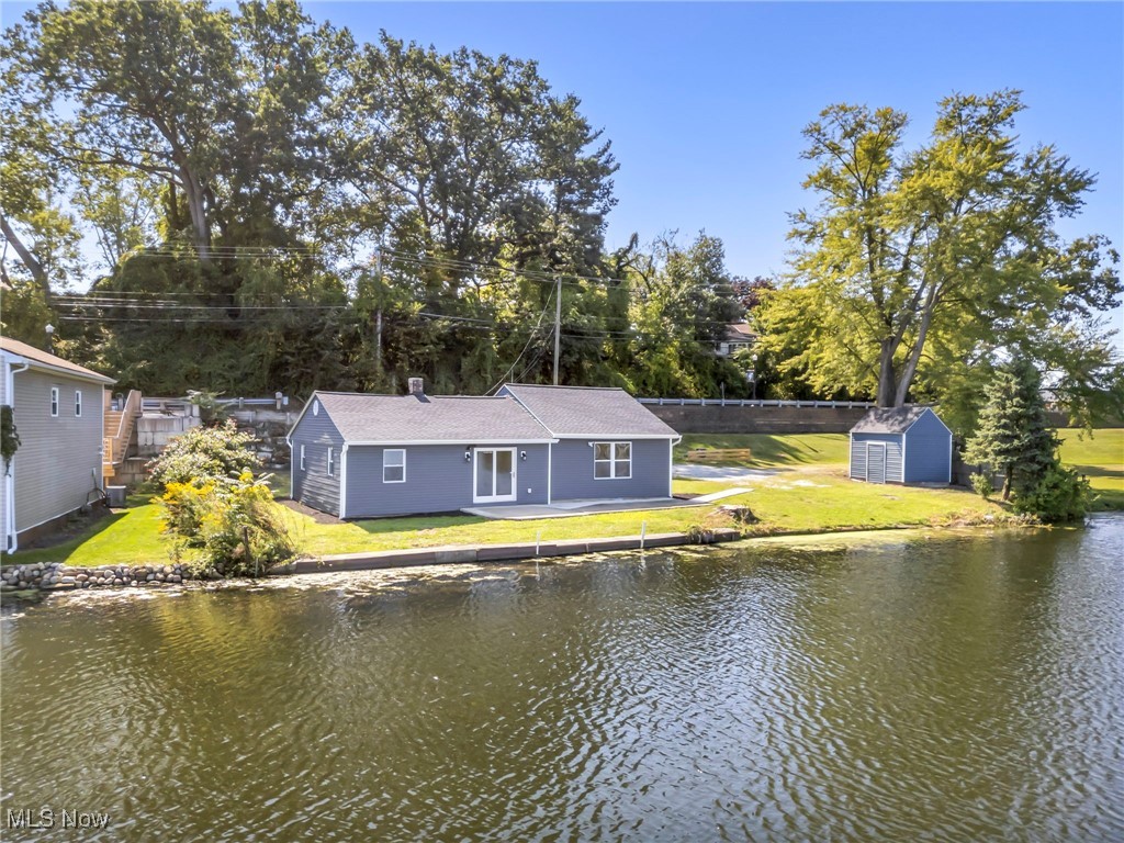 WHAT A VIEW! Step right outside and be on the water. One of the best views on the Lake. 3 bedroom, 1 bathroom Ranch, sitting on an incredible lot ON Long Lake/Portage Lakes. High class design and high quality craftsmanship. Open floor plan with open sight lines in kitchen, dining room, living room. Split floor plan bedrooms. A very efficient and practical layout. You will be proud to call this home. A great investment for owner occupant or AIR BNB.This home has been completely renovated and updated. EVERYTHING is new in 2024. Roof, Windows, HVAC, Doors, Kitchen, Bathroom, flooring, paint, lighting. NEW hookup to City Water. Septic is new in 2021. DID I MENTION THE VIEW?!