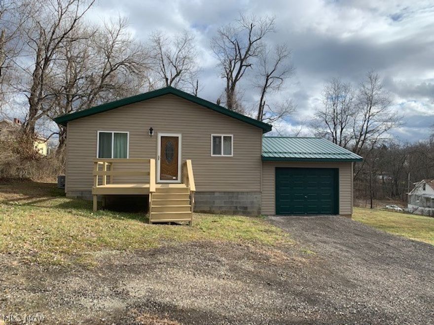 Newly built 2 bedroom home in 2018.  Metal Roof, Vinyl siding sitting on 2 lots.  Front and side porch with attached garage.