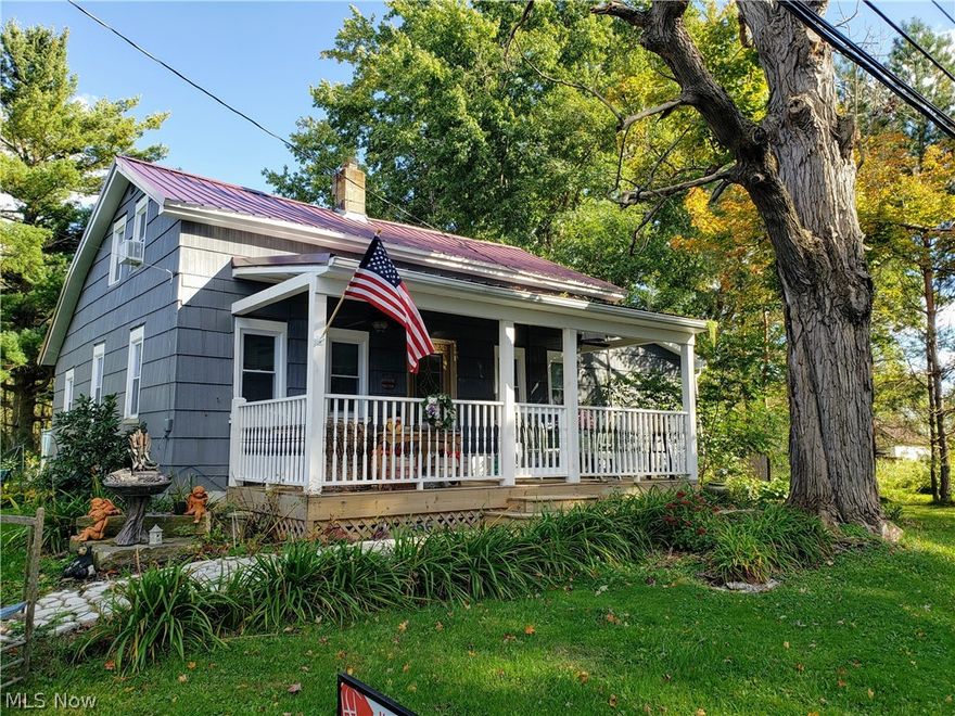 Charming Bungalow on 1.24 Ac.. Surrounded by plants for continuous blooms. Property runs wide & deep with a creek in the back. The home has newer windows and block windows in the basement, newer wood pergola flooring, marble vanity, marble walk-in shower & wood pergola flooring in bathroom with a large linen closet; Kitchen has brand new stainless steel appliances that stay & is surrounded by cabinets. Dining has a small pantry & coat closet. The front covered porch has double fans with lights and 2 electrical outlets for outdoor enjoyment. There are 2 decks on the back of the home, one with a dog run. Window unit A/C stays. Newer shed out back. City water, private septic. Newer metal roof. Many updates. Close to all amenities.