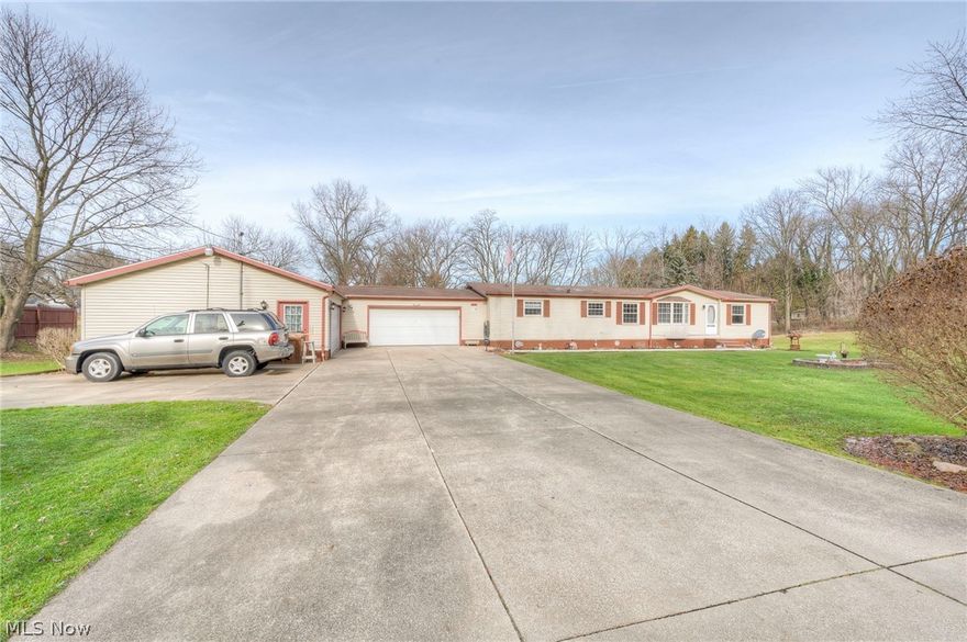 This beautiful 3-bedroom, 2.5-bathroom ranch home in Coventry Township is the perfect place to call home. Situated in a desirable Akron area, the home features a gas fireplace in the living room and wood floors throughout. Natural light floods the main level, highlighting the spacious master bedroom which includes a oversized tub, separate shower, and his and hers sinks with plenty of storage. A second bedroom also has its own bathroom. As well as a 1/2 bath. The full-sized finished basement provides added living space with carpeting, recessed lighting, and a potential 4th bedroom or craft area. Plus, extra storage and the furnace are conveniently located in its own finished area with extra shelving. Step outside and enjoy the large backyard with a wooden deck, hot tub stays but does not work, and privacy fencing off of the living room. There will be plenty of extra space in the 2 large attached garages. The largest one is 24X48. This charming home is being sold as-is and is ready for