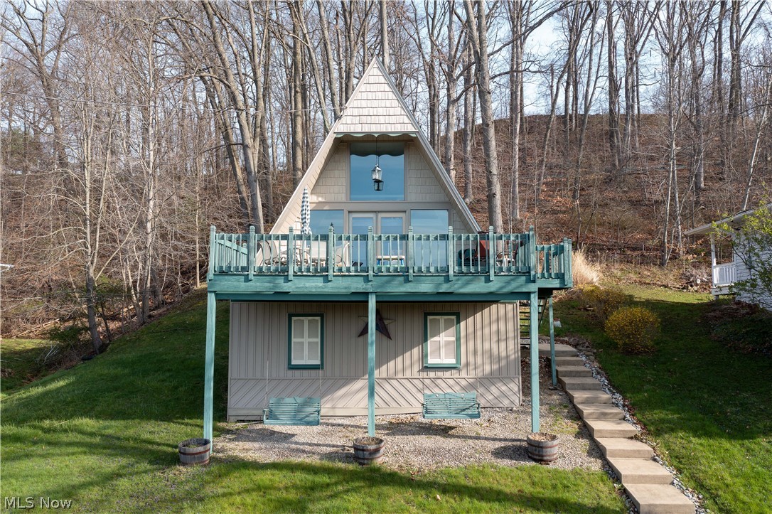 Great for a Summer/weekend getaway! This charming A-Frame home in Lake Mohawk is perfect for you and your family. The sizeable great room is bright and airy, and it features a cathedral ceiling, abundant natural light, and access to the large front deck. Enjoy a fantastic panoramic view of the lake from the great room from a wall of windows and glass front doors. The main floor also offers a lovely kitchen with white cabinets, a Quartz countertop, stainless stove & refrigerator, a full bathroom, and a bedroom. Upstairs is a lofted bedroom with fabulous views of the lake and a private back balcony overlooking the backyard. There are numerous parking spaces, a back patio, and ample storage space for lake/boat equipment underneath the home. Desirable and private lake community in Malvern boasting a 500-acre stocked lake with unlimited horsepower, 9-hole golf course, three beaches, clubhouse, and more! One of Ohio's best-kept secrets!! Lake Mohawk is 45 minutes southeast of Akron & 25 minu