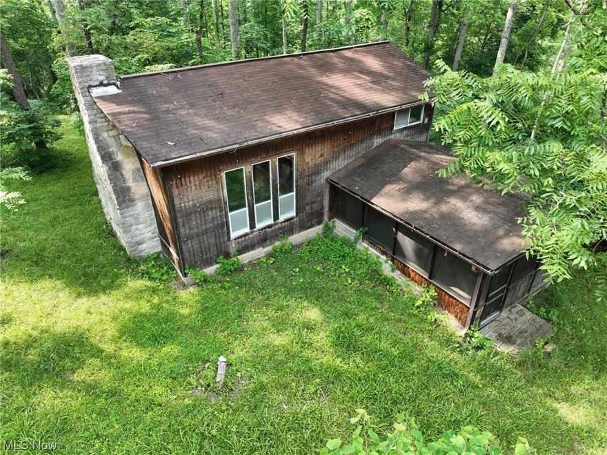 This two-bedroom rustic cabin is the perfect getaway for those who love the great outdoors. With 80 acres of land and a pond, you'll have plenty of space to explore and relax. The cabin is tucked away in the middle of the woods, providing a peaceful and secluded retreat. The property also features nice trails for hiking and biking. Make your appointment today to experience the beauty of nature in a cozy and charming cabin. Located near Burr Oak State Park and the  Wolf Creek Wildlife Area.