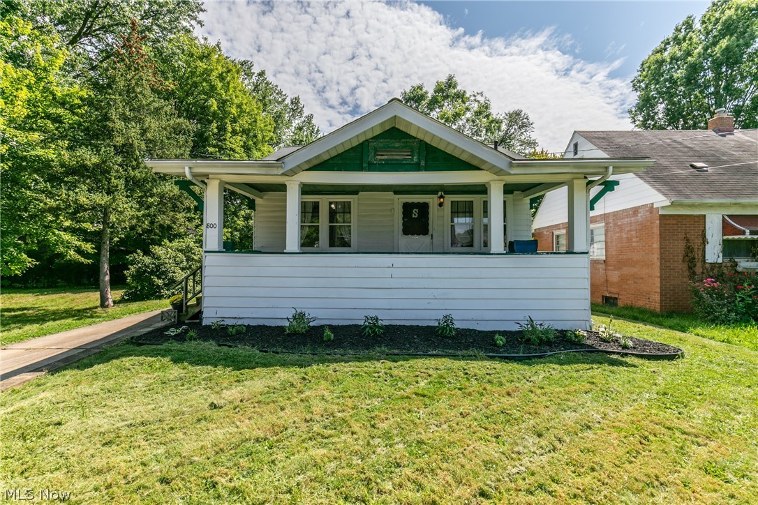 Welcome to this move in ready charming bungalow in Cuyahoga Falls! This home has a darling front porch, where you can sit and enjoy these beautiful fall days! The living room boasts a lovely fireplace and has a ton of natural light shining in. The living and dining room have stunning hardwood floors throughout. The kitchen has all been updated with white cabinets, stainless steel appliances and gray subway tile to accent the white granite countertops! Two nicely sized bedrooms and a third area upstairs to make your own office or rec room. The basement has a partially finished room as well as another bathroom. This home will not last, check it out today!