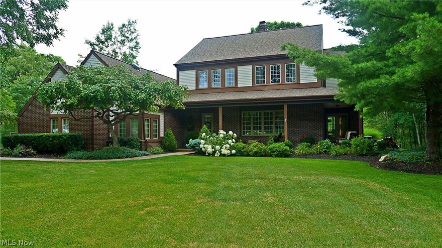 Beautiful Brick and Vinyl Colonial in Historic Hudson looks like something pictured in a Southern Living magazine.  A welcoming stamped concrete wrap-around Veranda and a professionally landscaped yard is the perfect recipe for great curb appeal. This 5 Bdrm 3.5 Bath Home offers gleaming maple wood floors, newer Kitchen with granite, stainless steel appliances, can lights and a walk-in pantry overlooking a family room with cathedral ceilings and a gas fireplace. Large formal Living Room and Dining Room with French Doors leading to the verandah.  Screen-in Porch off of the Kitchen leading to an outdoor stamped concrete Patio overlooking a very private large wooded lot . First floor laundry and mudroom with a separate entrance from the outside. Master Ensuite with tray ceiling, an updated master bathroom, Jacuzzi tub, tiled shower and double sinks.  Second floor loft overlooks the Great Room and has a bright and cozy Bonus Room with two skylights. A Hall Bath and 3 large bedrooms round o