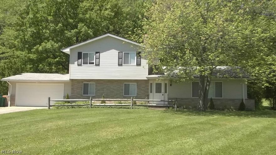 Wonderfully updated Kirtland split level! Newer kitchen features wood floors, maple cabinets with crown molding, granite counters, breakfast bar, stainless appliances (stove, refrigerator, microwave, dishwasher), open to spacious family room with fireplace & sliders out to rear deck. 2 full baths, completely remodeled with custom ceramic tile surround, dual sinks, jetted tub(1st floor full bath has cool basin sink and shower!).  Other features: formal dining room, huge living room, gorgeous hardwoods throughout the 3 large bedrooms, master with double closets, 1st floor laundry, vinyl siding and windows, newer entry doors, all situated on 1 acre! New roof to be installed!