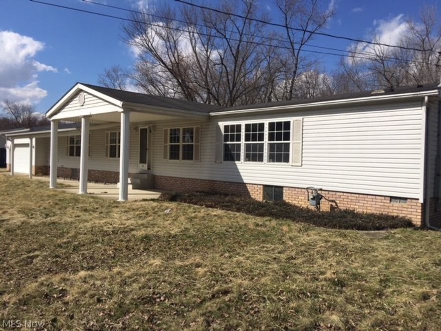 Spacious manufactured home with a peaceful backyard setting featuring a view of the stream.  Additional features include an enclosed sunroom, dining room, and attached double car garage.