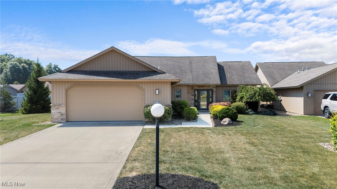 Tucked on a premium lot in the highly sought after Ridgefield community, this thoughtfully designed ranch offers the perfect blend of comfort, style, & low maintenance living. Built in 2016 by Bob Schmitt Homes, the home welcomes you with an expansive foyer that sets the tone for the quality & openness found throughout. Just off the entry, a versatile den with double doors & expansive windows offers the ideal space for a third bedroom, home office, or cozy retreat. As you move into the heart of the home, enhanced by soaring ceilings & natural light, it feels like stepping into a page of AD magazine. The living area is anchored by a striking stone fireplace & flows seamlessly into the open dining space & kitchen, where sleek countertops, stainless steel appliances, a large island, walk-in pantry, & custom built-ins provide both elegance & function. A guest powder room, a sizeable laundry/mudroom, & an oversized two car garage with nature stone flooring add convenience & thoughtful design. The garage also includes hot & cold water access, added storage, & pull-down attic access. Both bedrooms are spacious & private, each with a spa-like en suite bath, double vanities, & generous walk-in closets. Either can serve as the primary suite, & they are strategically placed on opposite sides of the home to maximize privacy. The dining area & one suite open to a tranquil screened-in porch featuring phantom screens, a perfect spot for morning coffee or peaceful evenings. In total, the home features three coated patio spaces, including a covered pergola with electric already run, complete with ceiling fan & integrated lighting, making it perfect for entertaining in comfort & style. The property also offers a full irrigation system, upgraded water system, & low maintenance landscaping. Residents enjoy access to Ridgefield’s vibrant amenities including a clubhouse, fitness center, outdoor pool, & walking trails, creating a lifestyle that is as connected as it is carefree.