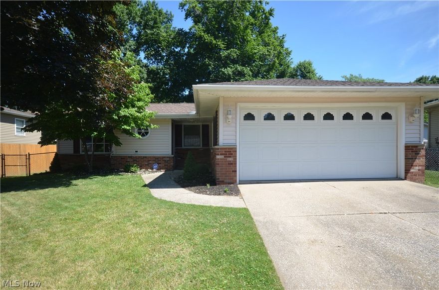 Tallmadge Schools! Move in Condition ranch w wide open layout & Big tickets (Roof, Windows, Furnace & A/C) already updated- plus cosmetics! Fenced in back yard w shed & patio. 2 car garage w opener, electric & cold water. Shining refinished hardwood floors (Liv, Hall & bedrooms). Front entry w great mud rm setup- open shelving & storage. Living rm w bay window providing daylight plus a cutout for open view to the spacious kitchen/dining area- into rear family rm. Tile floors, mint condition cabinets, beautiful subway tile backsplash highlighted by under cabinet lights- plus a solid surface counter w integrated sink. Giant dining area w great elbow room. Wide open layout to the sunken family rm w full wall brick raised hearth wood burning fireplace w mantle. Slider to the wrap around 3 season sun rm w tile floor. Updated main full bath -gorgeous vanity w granite counter & glass vessel sink- plus custom tile surround in the shower/tub & updated flooring. Master bedroom w ceiling fan, har