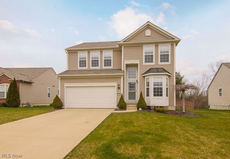 Welcome home to 3499 Hastings Dr.  This Pulte built Colonial boasts 4 bedrooms and 4 bathrooms on a fenced in yard.  The open concept first floor features hardwood floors and newer carpet overlooking the large deck and wooded area behind the home.  Perfect for the kids and summertime cookouts.  The second floor boasts a huge master bedroom complete with walk in closet and en suite bath.  The basement is finished with a recreation room, office/work area with built in's and a full bathroom.  Workout room or private office completes the lower level.  Call to schedule your private showing today, in this market this home won't be available long! Seller paid home warranty for your peace of mind!