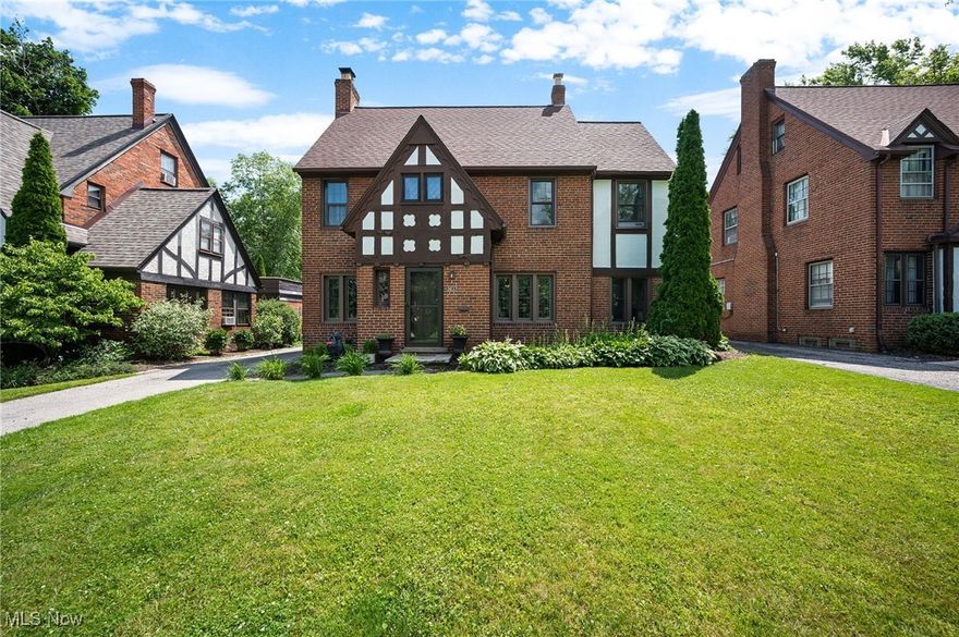 A sussex neighborhood tudor loaded with modern updates while maintaining its original character? Say less. Say hello to this bright and airy 3 bed, 2.5 bath (yes, there's a half bath on the main floor!) tudor-styled gem in one of the hottest areas of Shaker Heights. You'll love the gleaming original hardwood floors throughout the main level, freshly sanded and stained ('24). Off the dining area, you will notice a cozy and sunlit reading room, home office, etc! The updated kitchen features contemporary finishes, stainless steel appliances, and ample storage while still complementing the home's classic aesthetic. Enjoy a perfect blend of historic character and modern convenience, featuring all updated appliances ('20) for peace of mind, plus new windows ('24) ensuring comfort and energy efficiency. As you head upstairs, you will notice the primary suite serves as a true retreat, featuring a spacious bedroom, ample closet space, and a beautifully updated en-suite bathroom with modern finishes. The two additional bedrooms are perfect for guests, family, or home office - and share access to a second full bathroom, conveniently located just off the hallway. Whether you're looking for room to grow or flexible living space, the upper level offers a smart and stylish layout that fits your needs. The versatile fully finished third floor offers endless possibilities – a private home office, bonus room, or your own personal rock climbing studio! The partially finished basement adds even more flexible space, ideal for a workout area or media room. Current owners built a custom bar with live edge floating shelves and built-in space for beverage coolers. Enjoy your own private oasis in the fully fenced backyard ('20) complete with a stone patio and freshly grown grass ('25), giving you outdoor hosting space. This home is ideal for those who appreciate historic charm without sacrificing modern convenience. Walkability to Sussex park AND Van-Aken! This is true Shaker Heights living.