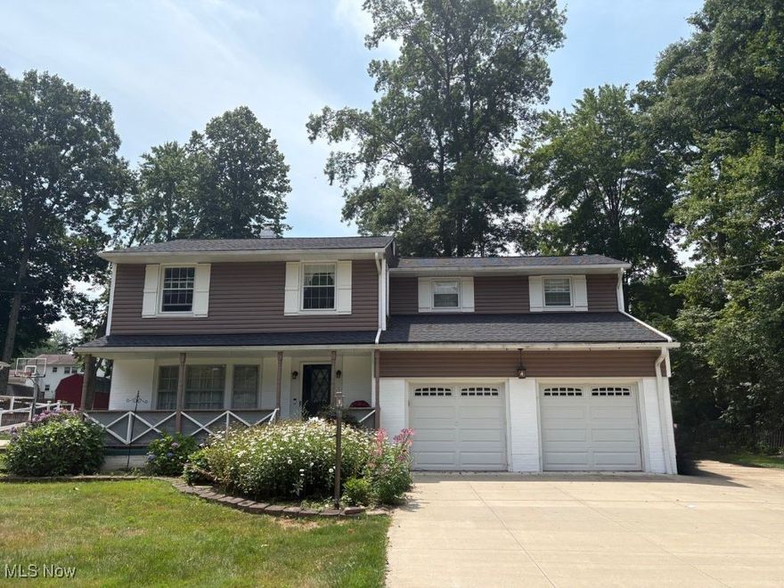 Don't miss this beautiful 4-bedroom, 2.5-bath colonial in a desirable Tallmadge neighborhood surrounded by mature trees and spacious lots. The first floor offers a formal living room, formal dining room, half bath and a cozy family room with wood-burning fireplace. There's also an updated kitchen featuring a double-sided pantry, dining space, and a charming pocket door. Natural wood flooring, built-ins, and abundant natural light enhance the main level. The real showstopper is the comfortable and large 4-seasons room which overlooks the backyard and new patio deck—perfect for relaxing or entertaining.

Upstairs, the rare butterfly staircase separates an enormous primary suite with ensuite bath from the additional three bedrooms and remodeled full bath, offering both privacy and functionality. All bedrooms are generously sized—two with natural wood floors and two with newer carpet. The basement provides excellent storage or recreation space, an additional refrigerator, and laundry area with washer and dryer.

Set on a 0.4-acre lot, this property includes a fenced area enclosing the patio deck, a playset, and a driveway with extra parking beside the two-car garage—ideal for additional vehicles, a boat, or an RV.

Updates include: Roof (2024), Main Sewer Line (2024), Hallway Full Bathroom Remodel (2024), Carpet (2024), Fence (2024), Patio/Deck (2024).  Other mechanicals: Furnace (2012), A/C (2019), Water Tank (2015).