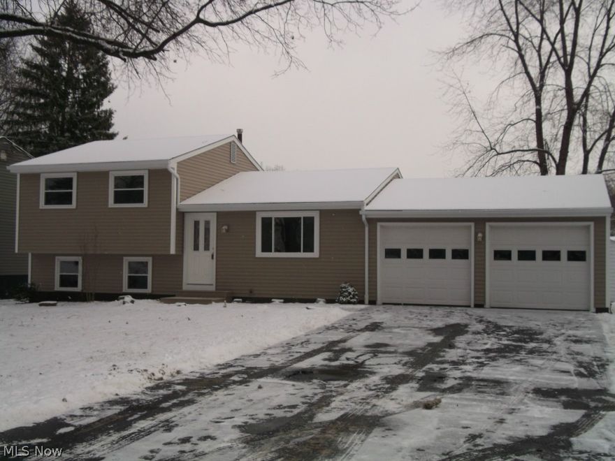 Beautifully renovated 3 bedroom 2 bath home with 2 car attached garage.  Features brand new eat-in  kitchen with oak cabinets, countertops, ceramic flooring, and stainless steel appliances.  Remodeled full bath with new tub surround, vanity, and flooring.  The lower level offers spacious family room, new half bath, and nice size laundry room.  Throughout the home are new interior doors, light fixtures, flooring, and freshly painted. The exterior improvements include new vinyl siding and trim, new porch flooring and railings, and newer vinyl windows. Hurry on this one, won't last long!