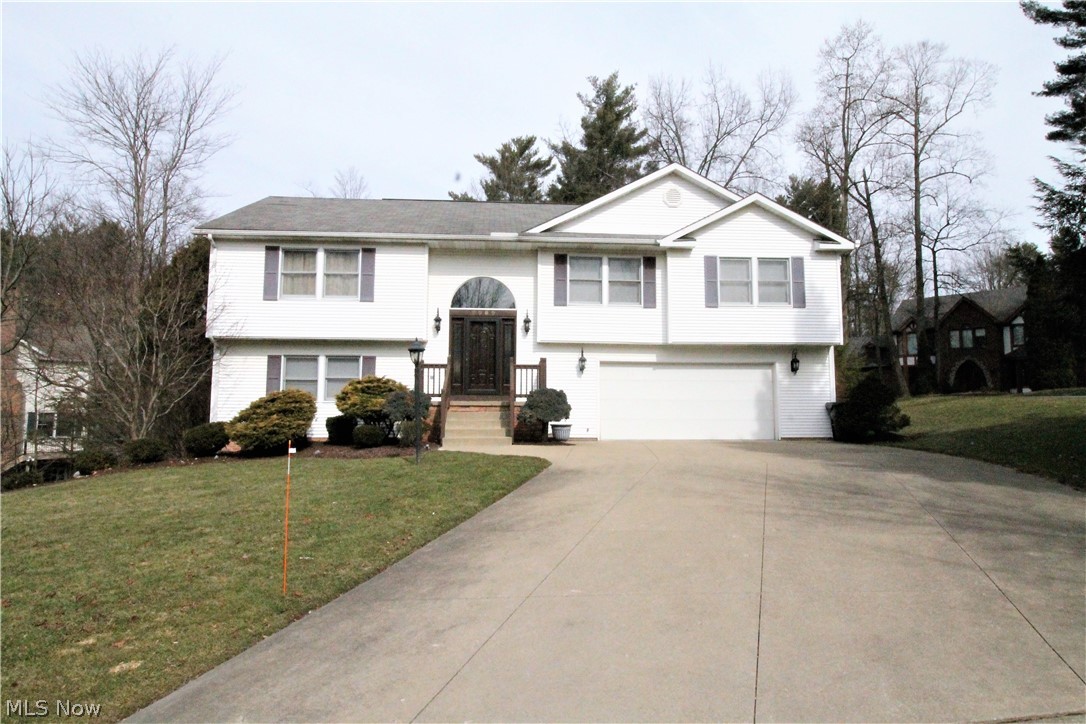 Welcome home to this fabulous four bedroom, two and half bath home with gorgeous private backyard with two-tier deck. The newer solid wood front door with sidelights takes you to the spacious two story foyer with extra wide staircases that leads to the family room which is open to the formal dining room and kitchen. The large kitchen has beautiful wood flooring, center island, plenty of cabinets and counter space. There is a spacious eat in area that has a sliding glass door to the deck to enjoy the sunlight. Three large bedrooms with plenty of closets and the bathroom vanities recently updated with soft close expresso drawers, corian counters and new faucets. One of the bedrooms is the large master suite with recessed lights and has a full bathroom and walk in closet. That finishes the beautiful upstairs, the lower level offers walk-out with rec room, gas fireplace, full bath and laundry room with laminate flooring. The fourth bedroom and or office has laminate flooring. The large d
