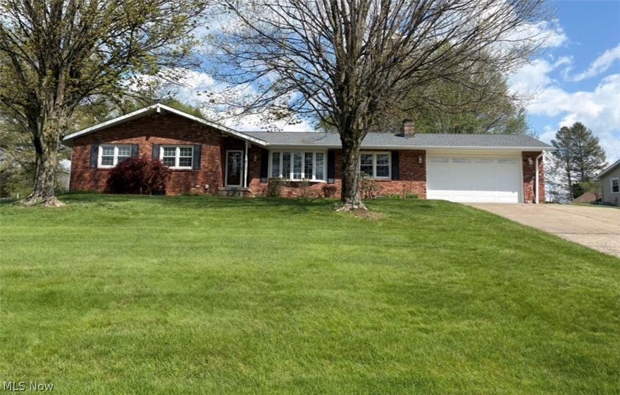 Hard to find well maintained brick ranch home with new roof on .93 acres outside city limits! You'll love this 3 bedroom, 2 bath home, big 2 car garage and huge detached 16X30 Amish shed with water, electric and garage door. The beautiful landscaped curb appeal draws you to it with newer windows and front door. Walk into the welcoming foyer just off the living room with lots of natural light from bowed window and includes a coat closet.  Dining room has beautiful Hickory Shutler cabinets with Corian counter and pullout drawers, nice corner closet and a walk out to the deck. Open eat in kitchen with Shutler Hickory cabinets pull out deep drawers, Corian countertop and backsplash, gas range, refrigerator, microwave and dishwasher. The bathrooms have Cherry Shutler cabinets. Family room with brick wood-burning fireplace, gas hook up. The lower level has a carpeted finished 25x24 finished rec room with a brick fireplace with wood burner plus a large unfinished area for weights storage or play.  Laundry area with new washer, dryer and sink. For outside entertaining, there's a nice covered 16 x 36 deck with uncovered area for sun, with skylights and fan. Huge backyard! This home definitely deserves a tour so book your private showing today! Home Warranty.
