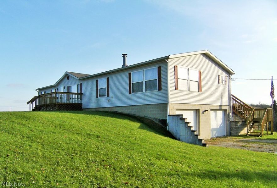 Less than 5 miles from the Seneca Lake Marina and sitting on 1.24 acres this 1716 square foot manufactured ranch home has all of the features of a full time residence or a weekend lake retreat. With vaulted ceiling throughout, the home’s large eat-in kitchen and adjacent great room epitomize today’s popular open floor plan concept. The great room has an attractive gas fireplace and large windows which shower the area with sunlight. The kitchen has oak cabinets, an island, and a built-in pantry. Sliding glass doors from the breakfast room provide access to a wonderful screened in porch with panoramic views of the surrounding countryside.  A more formal dining area separates the great room from a second living room. The master bedroom has his and her closets and a master bath with a free standing shower and a soaking tub. Two additional bedrooms on this level share a second full bath. A mudroom, laundry room with new washer and dryer and a half bath are conveniently located just off the