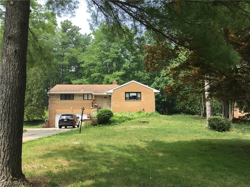 3 bedroom. 2 full bath brick ranch. Updated eat-in kitchen with extra cabinets, counters, and newer vinyl wood plank flooring. 2 wood-burning fireplaces. Three-season sunroom overlooks 1.03 acres of the private backyard. Heated garage with door opener. De-icing roof cables. Glass block windows in garage and basement. Central air. Located close to I-77 making it easy to get anywhere north or south. Great location, city and school district!!