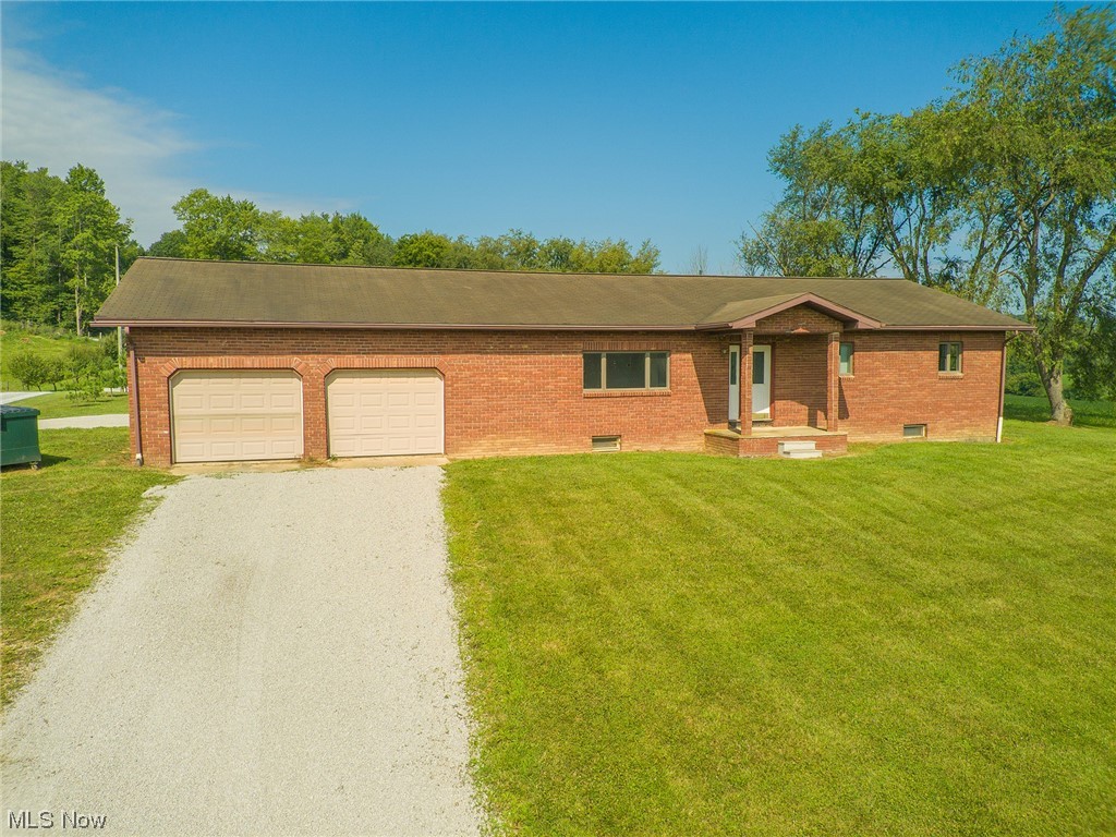 ONSITE AUCTION Thursday, September 7th at 6:00pm. Escape to your oasis in Holmes County, just northwest of Nashville! This move-in ready brick ranch home is nestled on 2.063 acres of serene country living. Boasting 3 bedrooms and 2 bathrooms, the open floor plan and modern kitchen gives a welcoming ambiance. New flooring throughout the home and updated utilities (newer water heater, water softener, gas forced air furnace and central AC) gives peace of mind in your investment. Outside, a sprawling backyard gives plenty of space for a garden or even a pasture and a second septic toward the back of the lot could add additional potential. An older outbuilding gives some storage options. Seize the opportunity to own a well-kept ranch home on an ample lot in a desirable location.