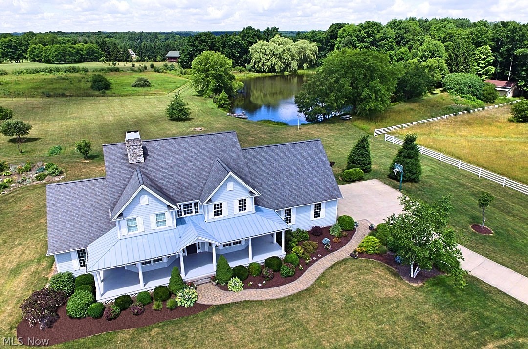 Welcome Home to this stunning colonial with 5 bedrooms and 3 1/2 baths. This open floor plan consists of a custom built kitchen with cherry cabinetry, granite counter tops, stainless steel appliances and beautiful birch floors. A separate mail/pantry room that could be used as a small office. First Floor Laundry and coat room. Vaulted living room with new carpet and a gorgeous 2 sided custom Tulikivi soapstone masonry fireplace. First floor master suite features porcelain tile, jetted tub, granite counter tops and a custom walk in closet. The finished basement is great for entertaining, has tons of storage and has stair access to the garage. House sits on a Permanent Wood Foundation System. This 9.5 acred parcel has a 3 stall barn with its own hay loft and storage area, 2 large pastures and an outdoor riding arena. A heated kennel with indoor/outdoor access and its own fenced in yard. Invisible fence surrounds the grounds. The breathless views can be enjoyed from the comforts of