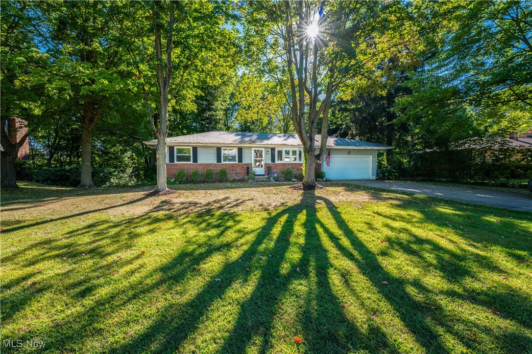 Welcome to this charming ranch in Norton, offering a perfect blend of comfort, updates and character! This well-maintained home features 3 bedrooms, each with hardwood floors. The living and dining rooms showcase newer waterproof vinyl flooring. The living room is highlighted by a large bay window that fills the space with natural light. The updated kitchen boasts quartz countertops, a double deep sink and gorgeous Schrock Cabinetry with a built-in China Display Hutch. Just off the dining room you will find a lovely 12x12 enclosed sunroom overlooking the beautiful private park-like, tree-line backyard. Step outside to enjoy the brick patio, complete with a natural gas line for the grill and a convenient storage shed. The finished basement offers even more living space with 20x13 family room, a bonus room currently set up as a billiard room and an additional area perfect for an office or hobby space. This home includes 1 1/2 baths on the main floor. The full bath has been beautifully remodeled and the half bath is conveniently located off the main bedroom. All appliances stay for your convenience. Additional highlights include a 2 car attached garage with opener, a newer furnace and A/C (2023) and a newer hot water tank (2016). Move-in ready and full of charm this Norton Ranch is ready to welcome you home!