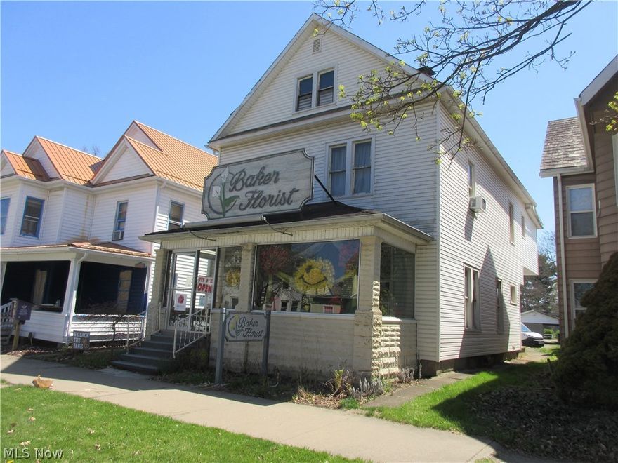 Excellent high traffic location for your business.  Spacious vinyl sided 2 story with 2,620+/- square feet.  10.6' ceilings throughout the first floor.  Gas heat, central air.  200 amp electric.  Enclosed front porch and rear patio.  32 X 28 detached garage.  Building only.  Business is operating at alternate location.  Zoned central business.