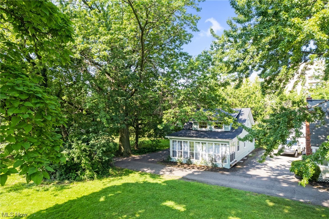 Adorable, move in ready cottage North of Lakeshore on a private drive in close vicinity to Lake Erie! This home has been extensively renovated included a new electrical panel, roof update and numerous cosmetics. Perfect for year round, low maintenance living, short term rental investment property or a beachy getaway! City of Euclid point of sale compliant. Enjoy lake breezes in the screened glass morning room off the front of the home. The kitchen features original character with a refresh. The main floor full bath has a claw foot tub and rainfall shower. Laundry and a large mud room or additional living space are also on the main floor. Upstairs are two nice sized bedrooms. Nothing to do but move in and enjoy!