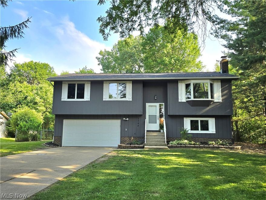 Beautifully Remodeled Brunswick Hills Home featuring 3 bedrooms and 2 full baths, nestled on a private & picturesque property; showcasing an abundance of updates inside & out! The brand-new roof, freshly painted exterior, refreshed flower beds, & new garage door boast a clean, modern style! Step inside to find desirable vinyl plank flooring, plush new carpet, & fresh paint throughout. The new lighting, hardware, trim & crown molding add a contemporary touch! The inviting foyer leads you upstairs to an amazing open floor plan that gives a new construction feel. The bright living room, featuring a bay window, flows seamlessly into the dining area & elegant eat-in kitchen. Gorgeous eat-in kitchen, complete w/ a huge custom center island w/ seating, ample white cabinetry, Quartz countertops, pantry, & brand-new appliances. Down the hall, you’ll find a remodeled bathroom w/ new double sink vanity & new tub w/ a tiled surround. The owner's suite offers convenient access to the bathroom, nice sized closet w/ organizer & a vaulted sunroom w/ walls of windows, overlooking the private backyard. Two more comfortable bedrooms also w/ closet organizers complete the main level. The lower level features a spacious family room w/ a cozy brick fireplace, a second updated full bathroom, & a large laundry room w/ plenty of storage space. Additional storage can be found underneath the staircase, in the deep 2-car garage & the large shed, which includes a concrete floor, walk-up attic, electric, & water access. Enjoy BBQ's, entertaining or simply relaxing on the large, freshly painted deck & spacious fenced-in yard w/ mature trees for added privacy. There’s even a chicken coop ready for feathered friends & plenty of room for your garden! Brand-new furnace (2024), new hot water tank(2024), electrical meter base(2024), A/C (2021), Anderson windows, & a 1-year home warranty. A true move in ready, must have home! Agent Owned.