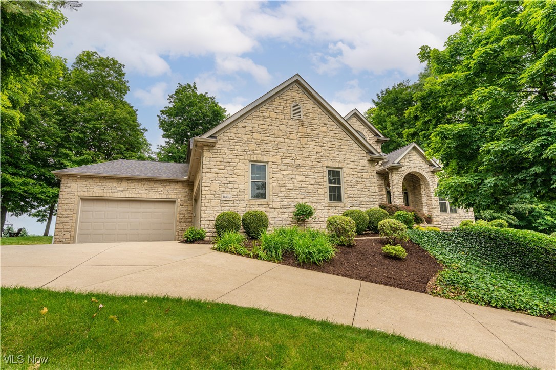 Gorgeous home, quality, custom built by Bugh Construction in Wellington Hills. Meticulously maintained,updated throughout. Upon entering you’ll find a spacious living room with ample natural light. The spacious, open dining room features custom-painted neutral walls.
The family room offers a gas fireplace, custom entertainment center and an oversized window overlooking a beautifully landscaped double-stream waterfall and patio. Beyond is a landscaped firepit.
The kitchen features refreshed Bolon cherry cabinets, granite, a breakfast bar, an island with an oven, and stainless appliances. The dinette area opens to the patio. The hearth room features cherry coffered ceilings and a custom entertainment center, a half bath, and skylight lit second stairway to the 2nd floor. French doors lead to the sunroom with a gas fireplace. Step outside to the patio to enjoy the calming waterfall.
The first-floor owners’ suite boasts a gas fireplace, walk-in closet, and patio access. The suite's updated bathroom (2020) has granite countertops, a slipper tub, and a spacious double shower with upgraded, spot-resistant glass.
The second floor catwalk overlooking the family room, leads to the skylit loft. The three bedrooms have been freshly carpeted and painted and the two bathrooms updated.
A finished lower level offers an entertainment space with a gas fireplace, pool table, and movie theatre area. There are cabinets for snack storage, a spacious room, a full bathroom, and a smaller room. A sliding glass door provides sunlight and outdoor access. Beyond is a large storage room with steps to one of two heated double car garages, one equipped with hot/cold water.
Whole house sound system, security system, Vacuflo with lifetime warranty. Front windows replaced in 2018, rear windows replaced in 2020. Roof replaced in 2019. Water heaters replaced in 2018 & 2023. First floor features Bella Cera engineered hardwood. The sprinkler system has been disconnected.