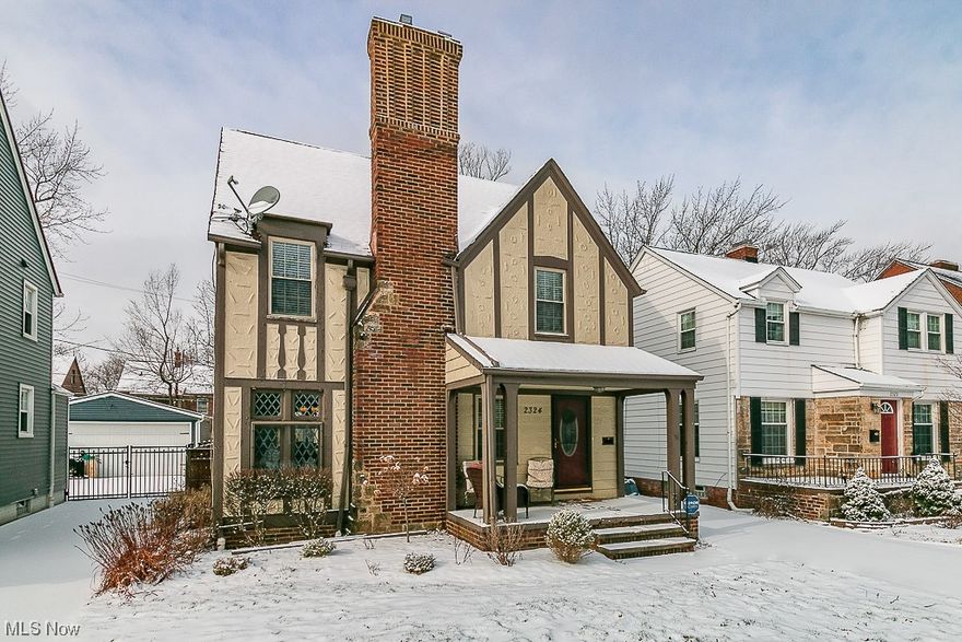 Get ready to be impressed by the charm of this Tudor-style home nestled in one of University Heights' most sought-after areas! This delightful residence boasts abundant natural light in the living/family room, showcasing beautiful original hardwood floors, stunning stained glass windows, and a wood-burning fireplace. The spacious dining room leads to a modern, fully updated kitchen (2019) with granite countertops, stainless steel appliances, a pantry with a granite counter shelf, and custom Shaker cabinets. The main floor also includes a convenient half bathroom. Upstairs, discover three generously sized bedrooms with ample closets, a bonus laundry chute, a full bathroom, and an iconic Tudor balcony! The updated lower level rec room provides additional living space, ideal for entertaining or unwinding with family. The laundry room and storage space are neatly tucked away in the unfinished part of the basement. Step into the partially fenced backyard, featuring a new entry gate (2020), a spacious deck, mature trees, and a newer 2-car garage (2019). Updates abound, including fresh paint, newer windows, toilets, AC (2022), furnace (2019), hot water tank (2017), and all appliances (2019). This home is move-in ready, complete with a security system and all appliances, including the washer and dryer! Conveniently located just minutes away from a variety of restaurants, shopping, cafes, John Carroll University, and Fairmount Circle. This charming home showcases pretty architectural details like arched nooks, two fireplaces, and crown moldings. Adored by its owners, this gem won't last long—schedule a viewing before it's gone!