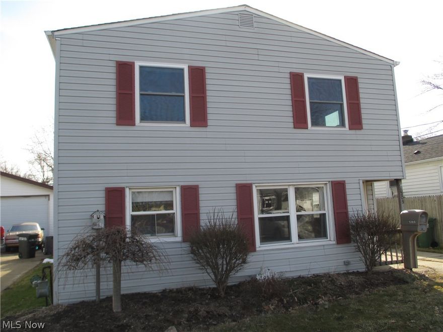 Curb appeal !  Colonial home with newer vinyl siding, 2 car detached garage, deck, and covered patio.  Needs cosmetic work inside.  Open floor plan with kitchen open to living room.  First floor bedroom with full bath and 2 bedrooms on second floor.  Easy access to schools, shopping, freeways and the shores of Lake Erie.