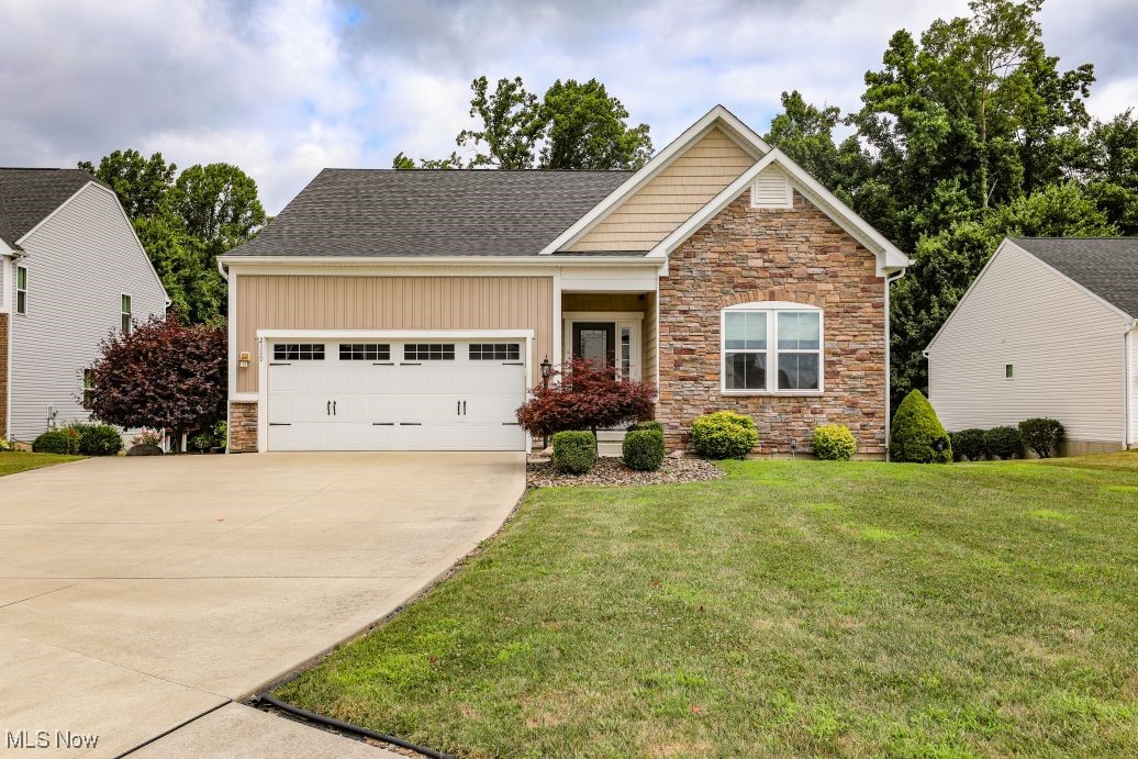 This meticulously cared for Ranch home located in Cranberry Creek in Brimfield Township offers 1,404 sq. ft. of living space on the first floor with 2 (possibly 3) bedrooms and 2 Bathrooms including a spacious primary bedroom with walk-in closet and en-suite bathroom. The large Great Room includes a kitchen with ample cabinetry, black appliances, an eat-in island and dining area. There is also first floor laundry, an office that could be used as a 3rd bedroom, a two car attached garage, and a full finished basement offering an additional approx. 956 sq. ft. of living/entertaining space with another full bathroom. Outside you will find a covered/enclosed porch with Trex decking, a large paver patio with stone waterfall water feature, built-in gas grill, along with beautiful low maintenance landscaping and a nice sized yard. Additionally, there is storage under the enclosed porch and a stone walkway at the back of the property. Schedule your showing for this move-in ready home today!